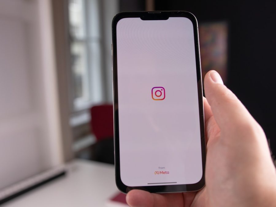 Hand holding a phone with the Instagram app open